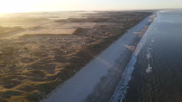 Aerial view of rolling waves and sunrise at the ocean close to Løkken by the North Sea, Denmark alt