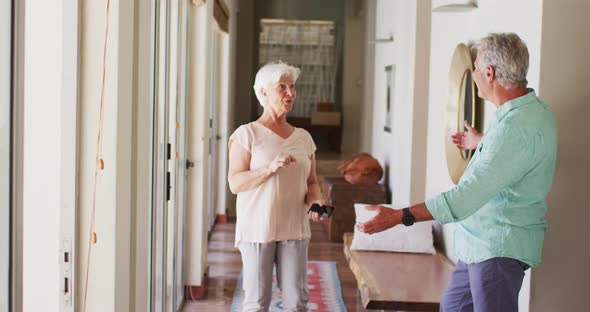 Happy senior caucasian couple dancing together at home alt