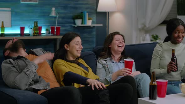 Multiethnic Friends Having Funny Reaction While Watching Comedy Movie alt