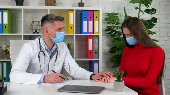 Doctor calm depressed woman after hearing diagnosis puts hand on patient hands alt