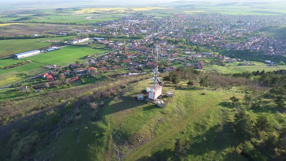 Fields with a Plant in a Valley Against the Background of the Village and the Sky in Bulgaria alt