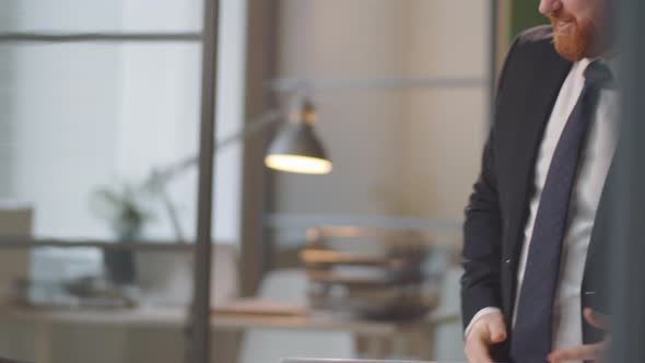Black Businessman Giving Handshake and Talking with Coworker alt