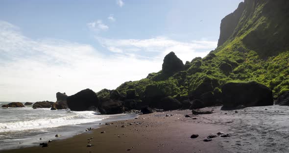 Black sand beach in Vik, Iceland with gimbal video walking in slow motion. alt