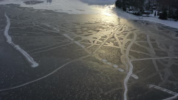Frozen Lake High Up Drone View In Winter With Snow Trails