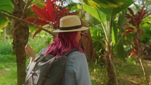 Outdoors Summer Adventure Woman with Backpack Walking By Tropical Jungle Forest alt