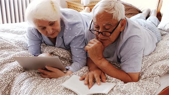 Senior couple using digital tablet alt