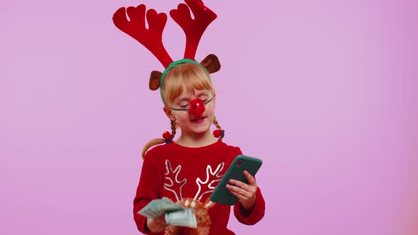 Girl in Red Christmas Deer Antlers Looking Smartphone Rejoicing Win Success Luck Receiving Money alt