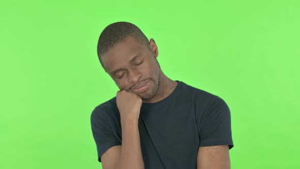 Sleeping Young African Man on Green Background alt
