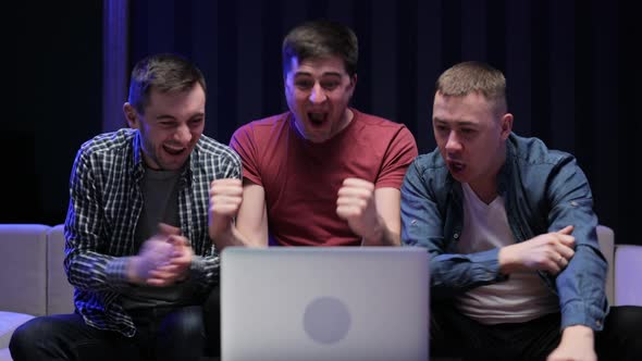 Male Friends Watching Online Football Game Match at Laptop