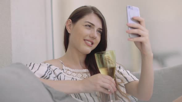 Woman taking a selfie at home