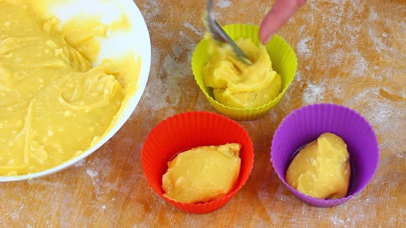 Woman Falls Asleep with a Spoon Yellow Dough in a Muffin Baking Dish at Home in the Kitchen alt