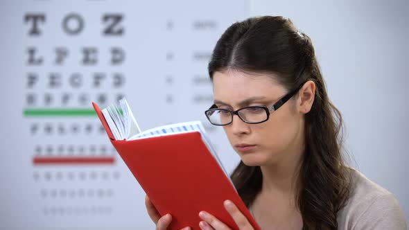 Woman in Glasses Suffering Myopia Reading Book, Need in Correct Lens Diopter alt