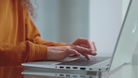 Female Hands of Business Woman Typing on a Laptop Close Up Side View
