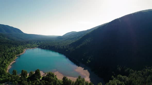 Beautiful Washington Nature Aerial With Turquoise Color Mountain Lake Surrounded By Trees alt