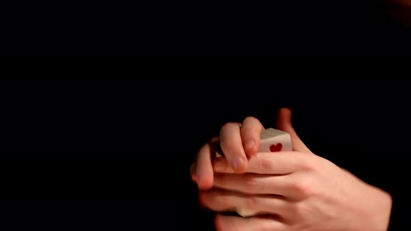 Playing Card Trick Making By Magician on Black Background alt