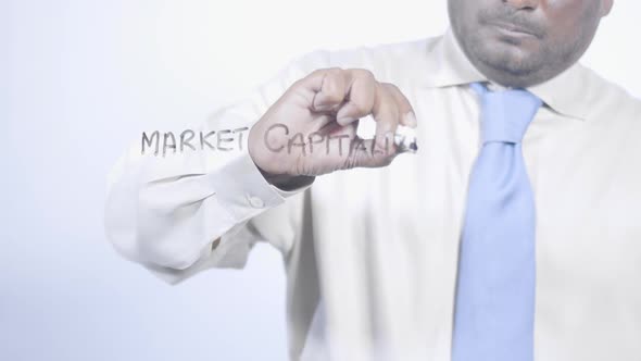 Asian Businessman Writes Market Capitalization