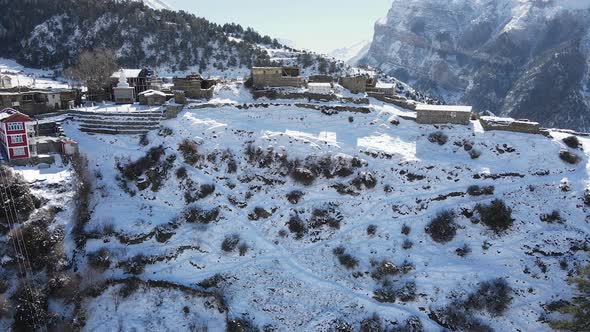 Aerial view of Ngawal Village covered in snow in the Himalayas alt