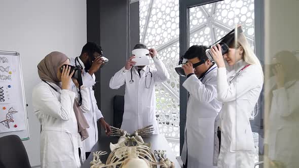Male and Female Doctors Wearing Virtual Reality Headset to Learn the Structure of Human Skeleton alt