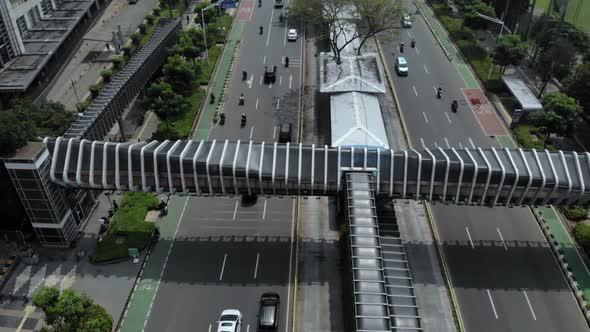 Cinematic aerial view of cityscape and crossing bridge with road traffic