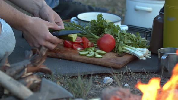 Close Up Man Tourist Hands Cutting Board Vegetables on Camping Trip