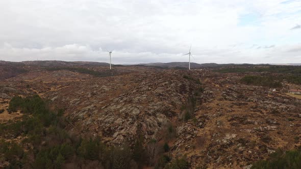 Lindesnes windpark ascending aerial with two windmills in center of frame - Flat nature landscape an alt