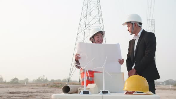 Two engineers experts discussed the construction of a power line. Teamwork, Leadership concept. alt