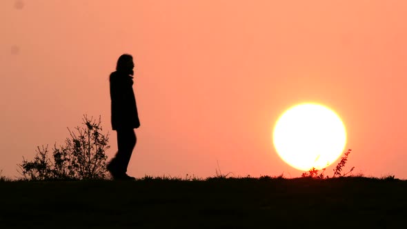 Man Walking his Dog at Sunset