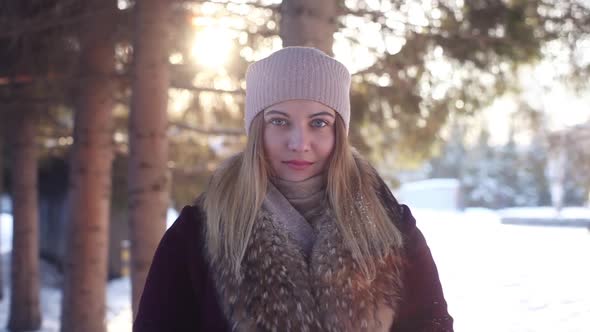 Young Girl Playing with Snow in the Woods in Winter Outdoors alt