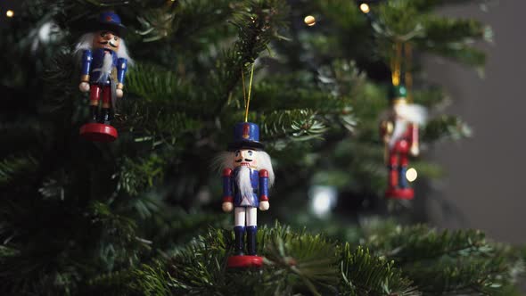 Nutcracker Soldier Toy on a Christmas Tree With Blurred Background Dolly 4K Shot. alt
