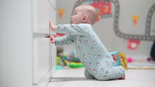 A Crawling Funny Baby Indoors at Home Play with Toys