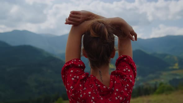 Back View Woman Raising Hands Standing in Front Beautiful Mountains Close Up alt