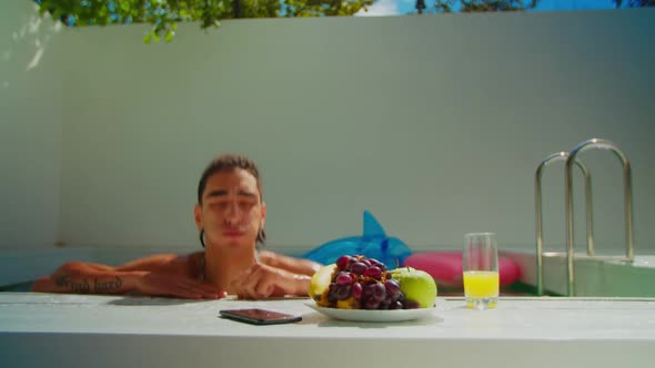 Arab Man Answering Phone Call in Swimming Pool alt