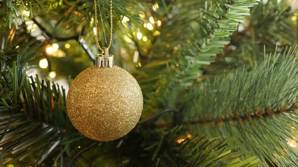 Close-up of golden color  Christmas ornament 4K 2160p 30fps UltraHD footage - Shiny fairy-lights and alt