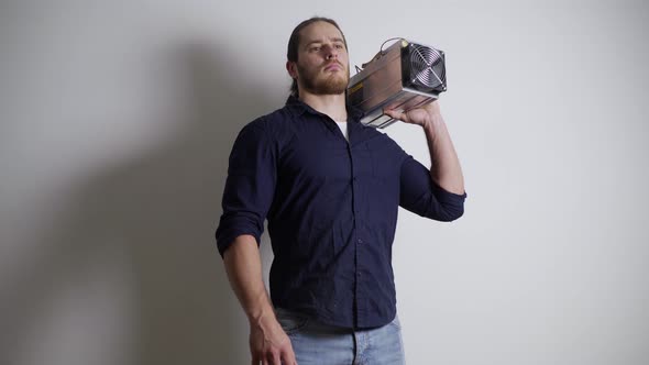 A Man of Athletic Build Holds a Mining Farm on His Shoulder Believes in Blockchain alt