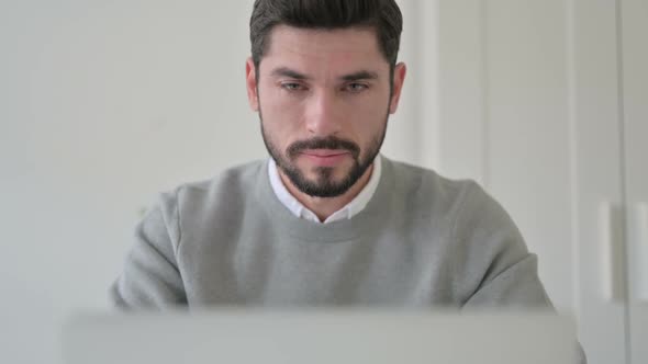 Close Up of Man Coughing While Using Laptop alt