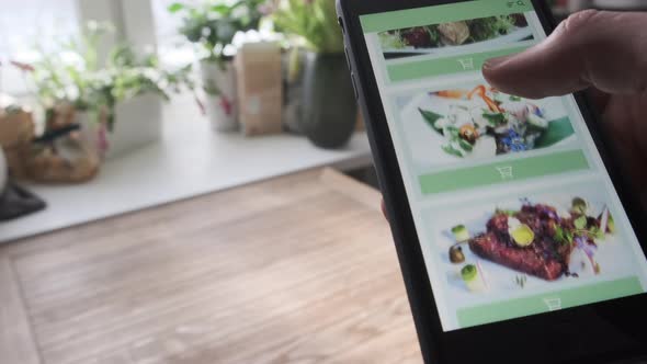 Concept of Ordering Food From Restaurant Online Using Smartphone App Close Up and Paper Bag with alt