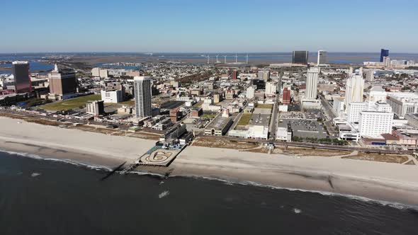 A slowly forwarding aerial view of the iconic Atlantic City shoreline and boardwalk. alt