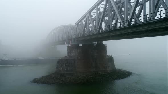 Barge passing under bridge in fog, Zaltbommel, Gelderland, Netherlands