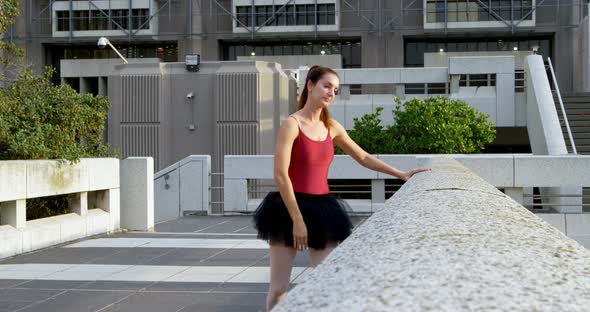 Ballet dancer stretching on pavement 4k alt
