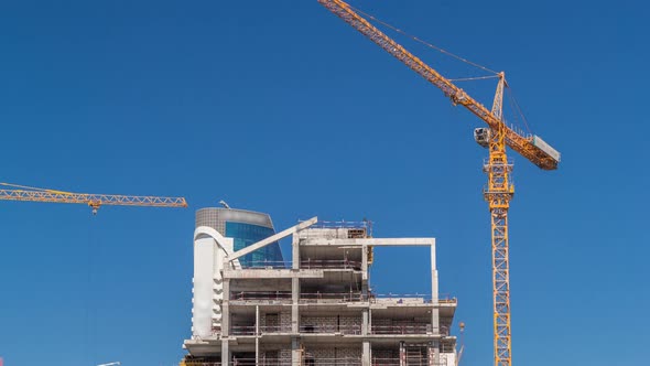 Aerial View of a Skyscrapers Under Construction with Huge Cranes Timelapse in Dubai alt