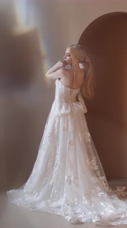 Young Blonde Woman in Elegant White Dress Posein Studio alt