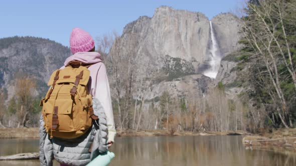 Woman Traveler with Drinking Water Hiking at Mountain River at Mountain Forest alt