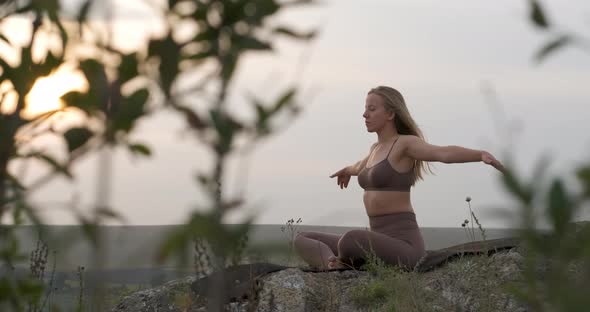 Athletic Caucasian Girl Meditating Outdoors Young Woman Practicing Yoga on the Nature at Sunset