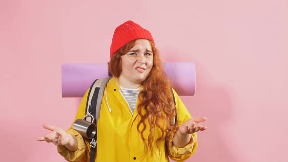 Serious Unhappy Woman with Clueless and Confused Expression Shrugging Her Shoulders. alt