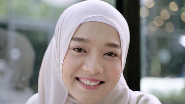 Close-up, beautiful Muslim girl smiling in hijab