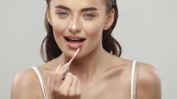 Sexy Young Girl Applying Lipbalm alt