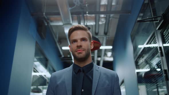 Attractive Businessman Going on Meetup in Business Center. Man Walking in Office alt