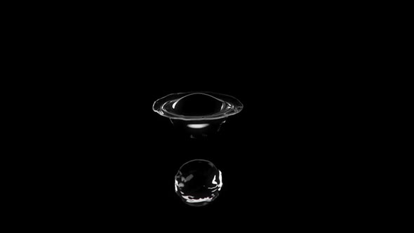 2 Drops Of Water Meet And Splash In The Air On A Black Background