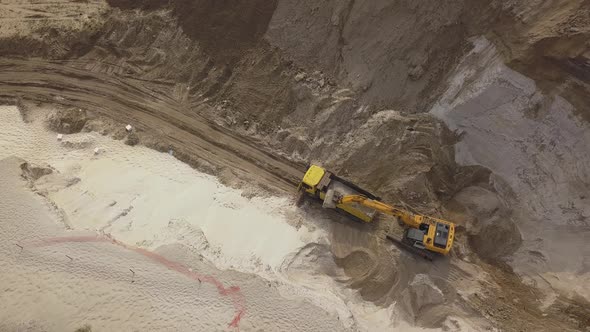 Excavator Load the Sand Into Dump Truck alt