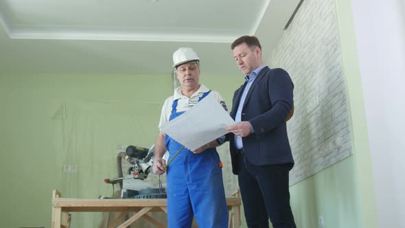 Architector And Builder Shake Hands At The Building Under Construction